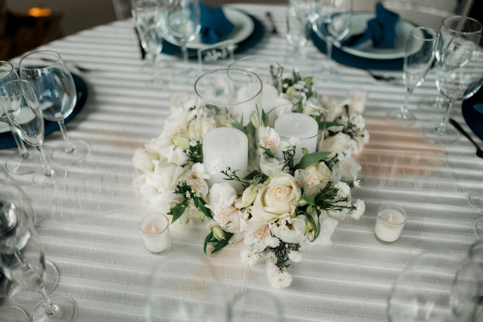 Brass taper candle holders on a dinner table with linen napkins